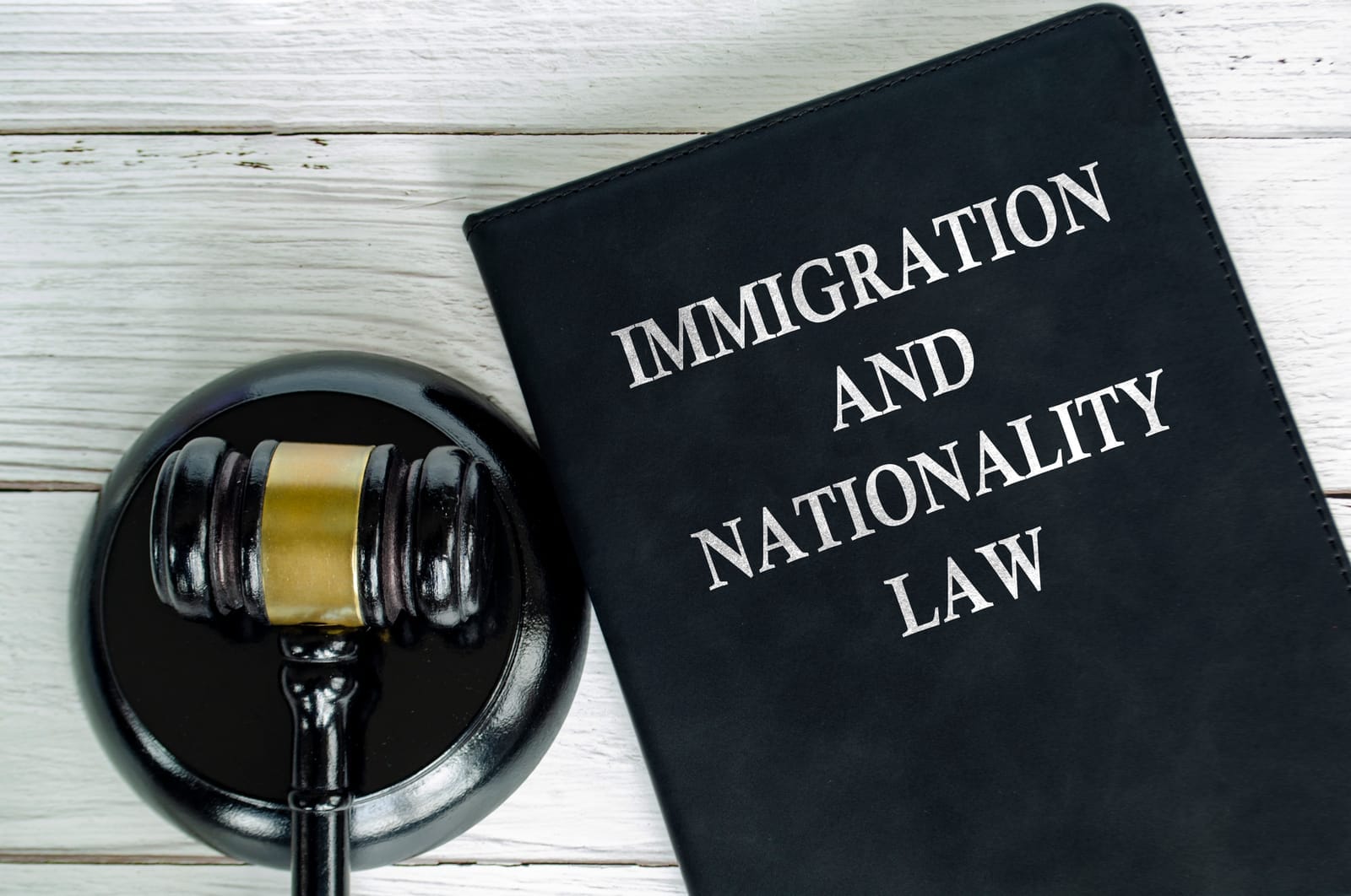Top view of Immigration and Nationality Law book with gavel background